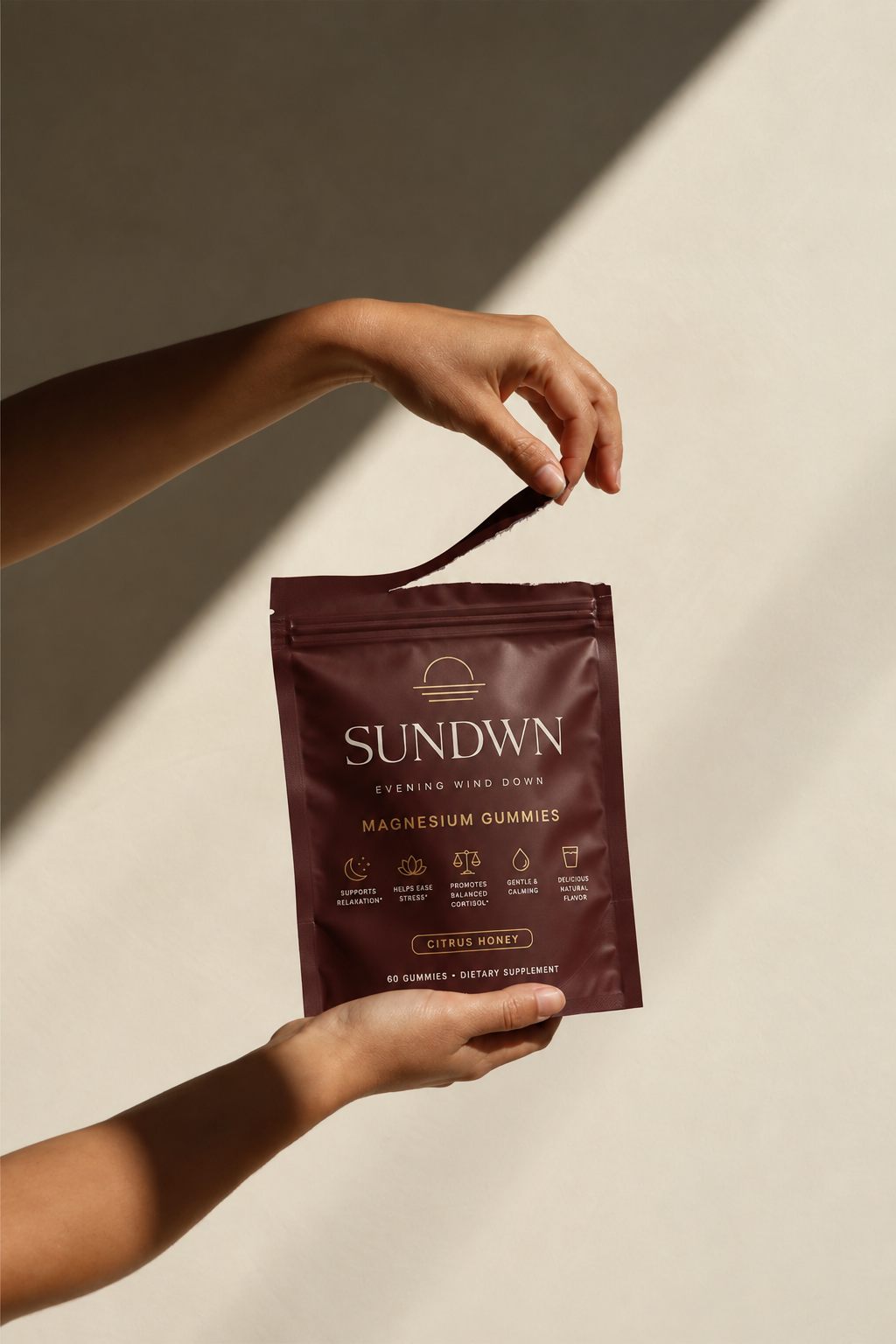 SUNDWN Evening Wind-Down Magnesium Gummies pouch being opened